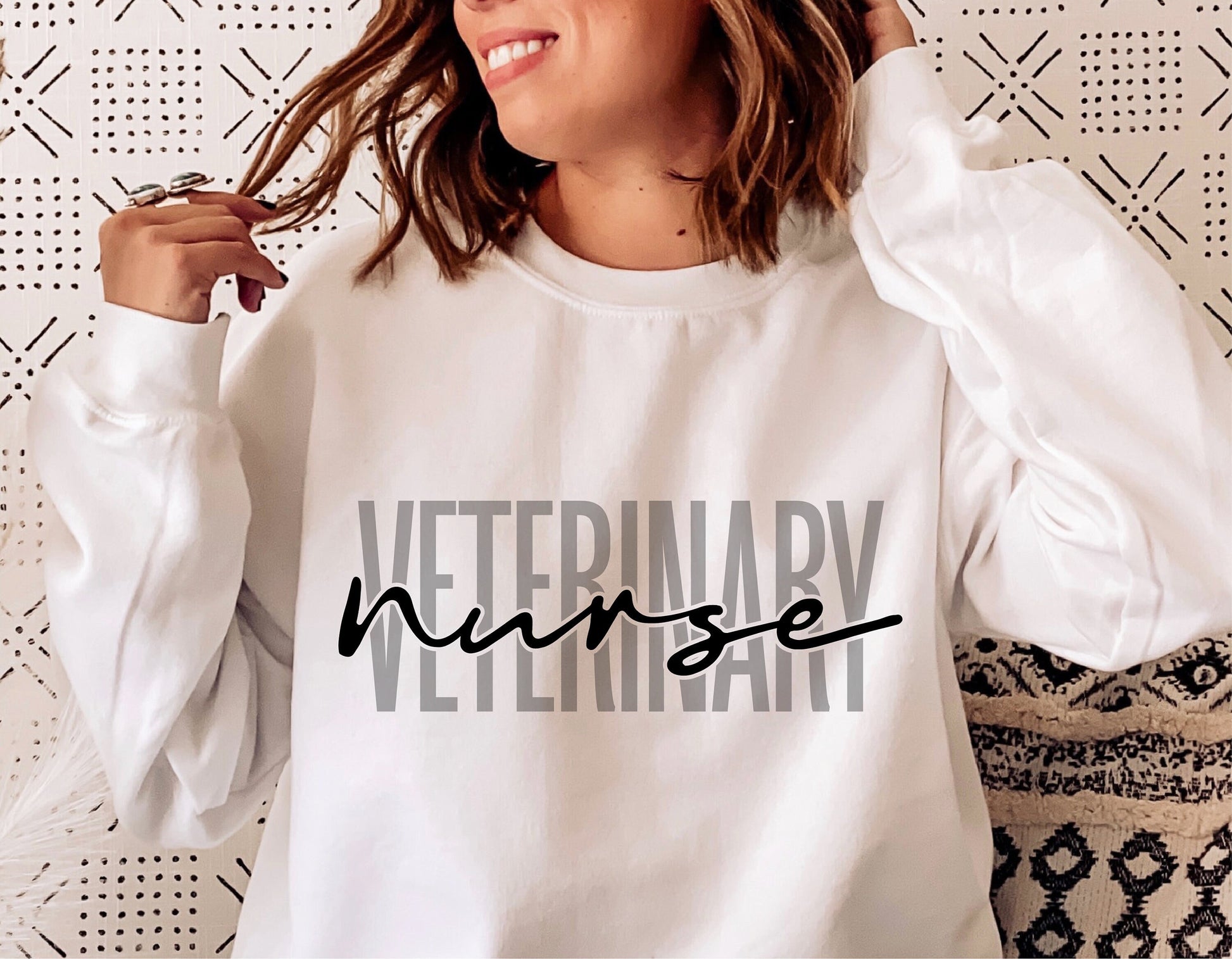 Woman wearing white sweatshirt with 'Veterinary Nurse' text, perfect for Cricut and Silhouette crafting. Digital download available.