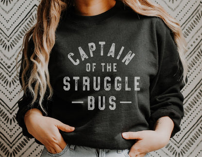 Woman wearing a black sweatshirt with 'Captain of the Struggle Bus' text, showcasing a funny sarcastic design for Cricut or Silhouette projects.