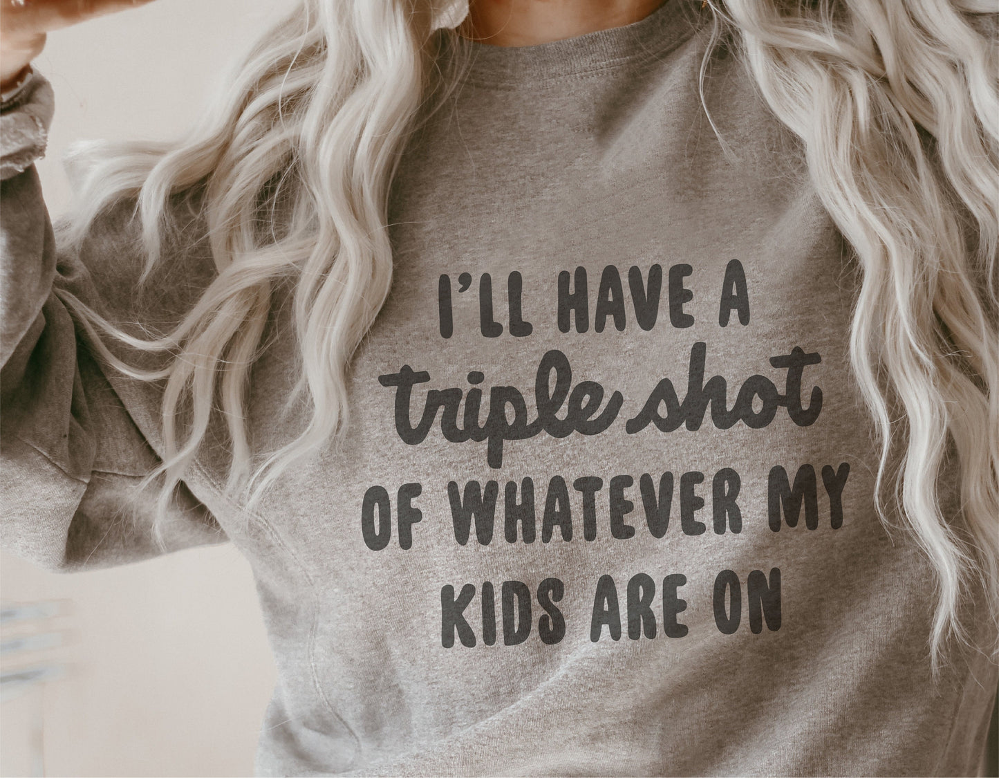 Gray sweatshirt with "I'll have a triple shot of whatever my kids are on" text, perfect for moms, funny apparel.