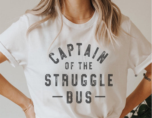Woman wearing a white t-shirt with 'Captain of the Struggle Bus' text, showcasing a funny SVG design for Cricut and Silhouette projects.