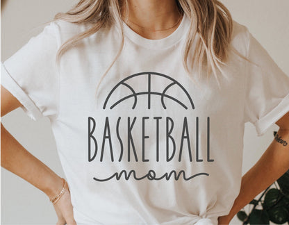 Woman wearing a white t-shirt with a 'Basketball Mom' graphic design, perfect for basketball enthusiasts.
