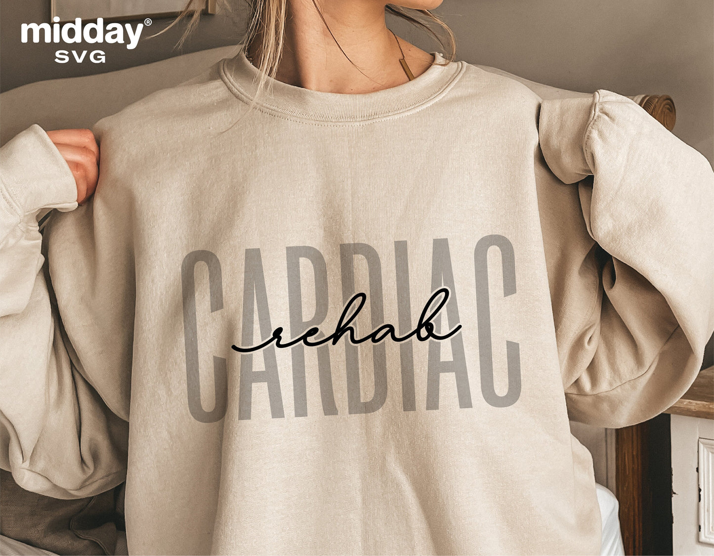 Person wearing a beige sweatshirt with 'Cardiac Rehab' design, suitable for Cricut and Silhouette projects, displayed indoors.