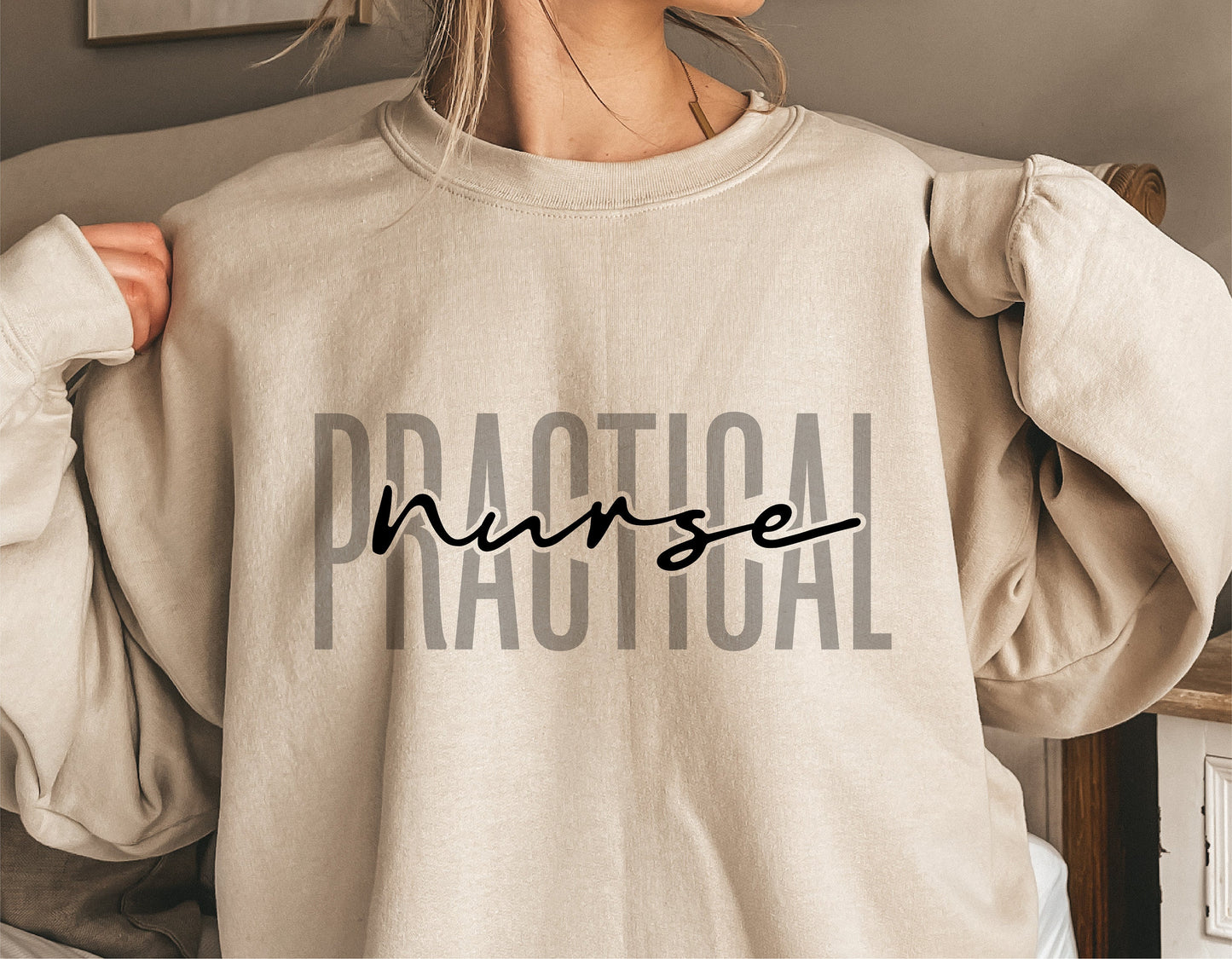 Woman wearing beige sweatshirt with 'Practical Nurse' text, showcasing nursing theme apparel.