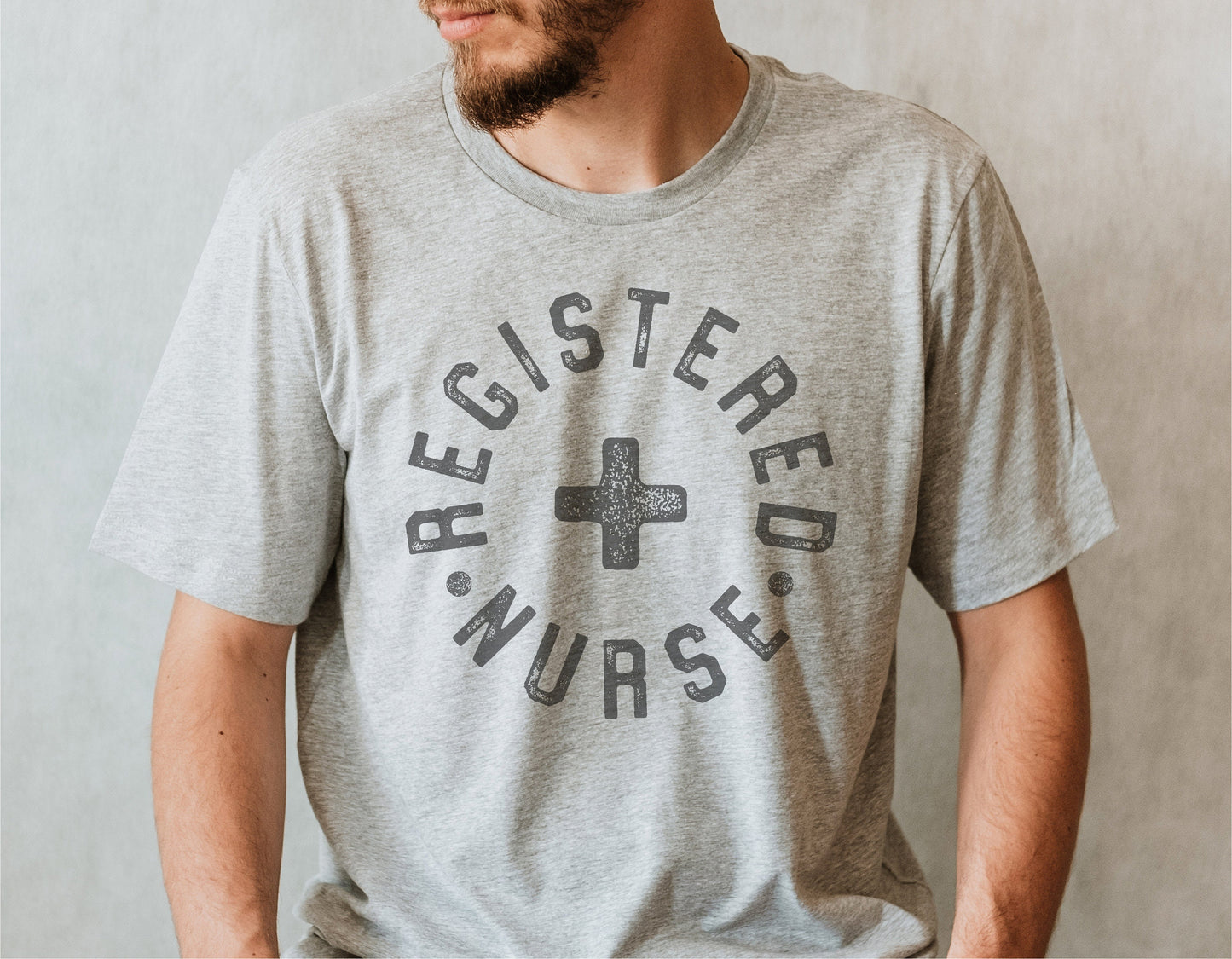 Male model wearing a gray 'Registered Nurse' graphic t-shirt suitable for medical professionals and casual wear.
