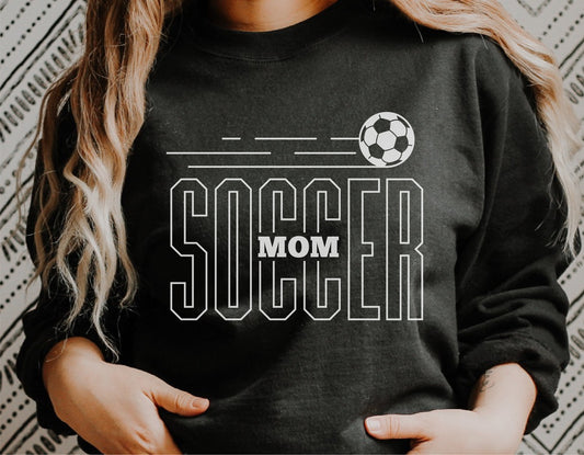 Woman wearing black sweatshirt with 'Soccer Mom' and soccer ball graphic design