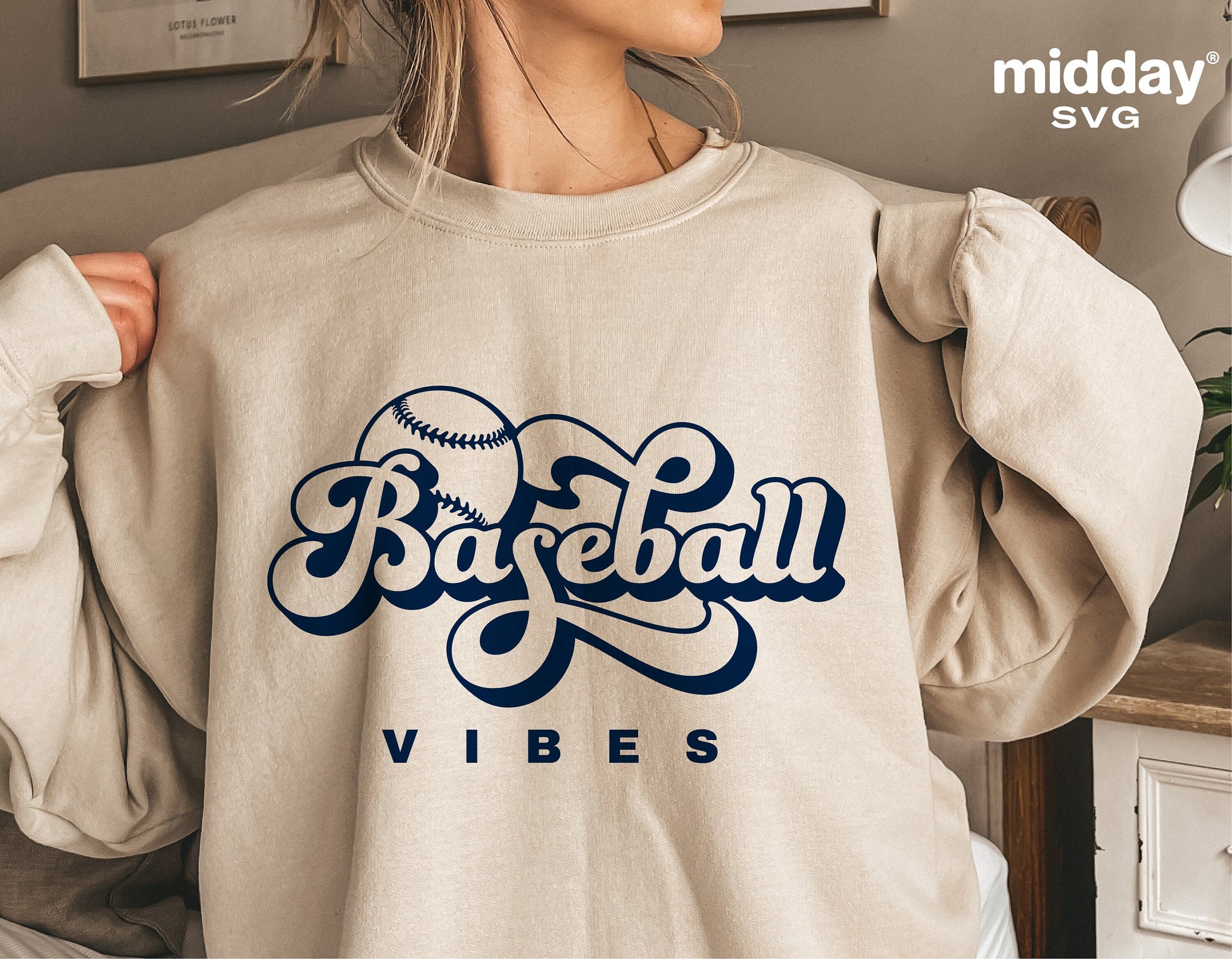 Woman wearing a beige sweatshirt with 'Baseball Vibes' and a baseball graphic, perfect for retro Cricut projects and sublimation.
