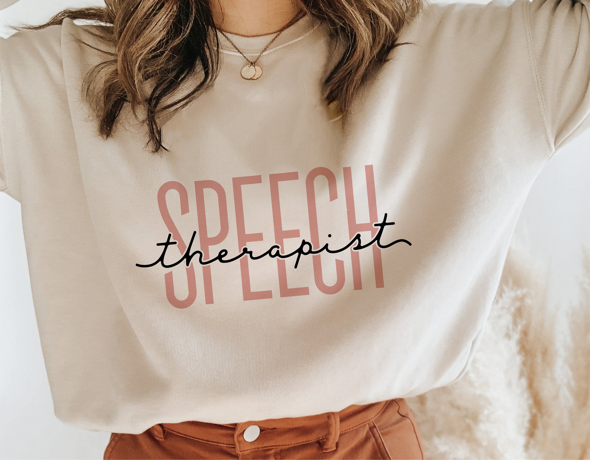 "Speech Therapist" text on a cream-colored shirt.