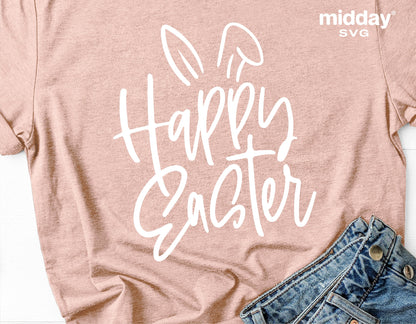 Tan shirt with 'Happy Easter' text design featuring bunny ears, accompanied by blue jeans. Ideal for Easter SVG crafting projects.