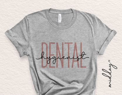 Gray t-shirt with 'Dental Hygienist' design in large printed text, ideal for dental professionals, compatible with Cricut and Silhouette cutting.
