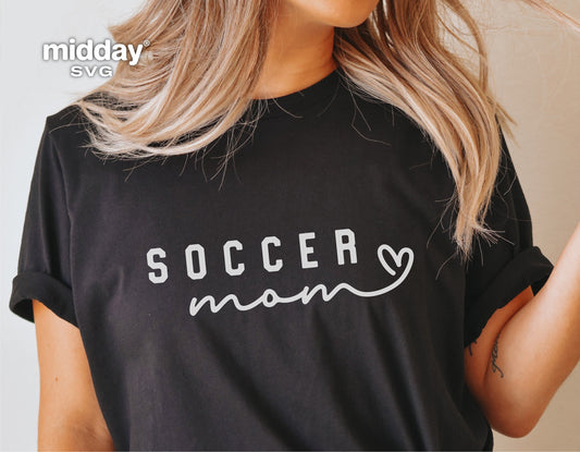 Woman wearing a black t-shirt with "Soccer Mom" graphic design, suitable for Cricut and Silhouette projects, ideal for soccer enthusiasts.