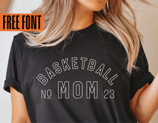 Woman wearing custom Basketball Mom shirt featuring 'No 23' design, showcasing free font for Cricut and sublimation projects.