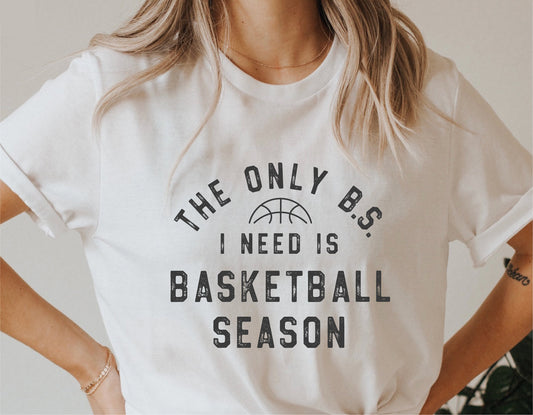 White t-shirt with 'The Only B.S. I Need Is Basketball Season' text design, ideal for basketball enthusiasts and Cricut cut projects.