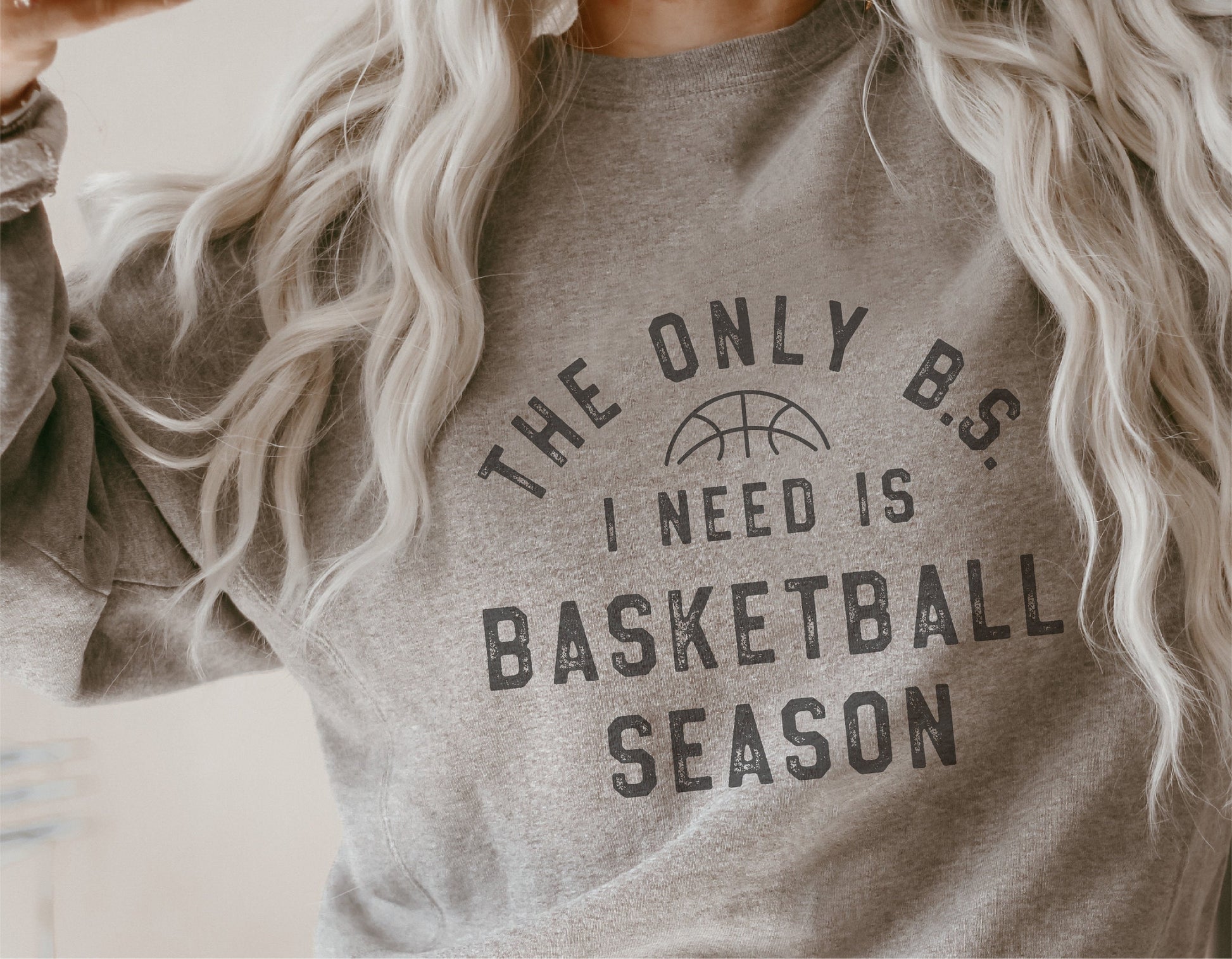 Cozy gray sweatshirt with 'The Only B.S. I Need is Basketball Season' printed text, perfect for basketball fans and sports enthusiasts.