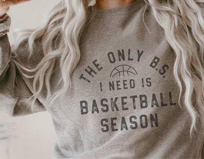 Cozy gray sweatshirt with 'The Only B.S. I Need is Basketball Season' printed text, perfect for basketball fans and sports enthusiasts.