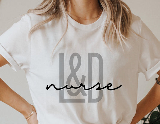 Woman wearing a white shirt with 'L&D Nurse' design, perfect for Cricut and vinyl cutting projects.