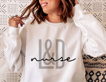 Woman wearing white sweatshirt with 'L&D Nurse' design, ideal for labor and delivery nurse svg craft projects.