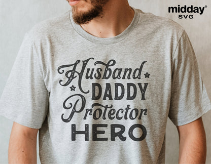 Man wearing a gray T-shirt with 'Husband Daddy Protector Hero' text, ideal for Father's Day gifts and Cricut crafting projects.