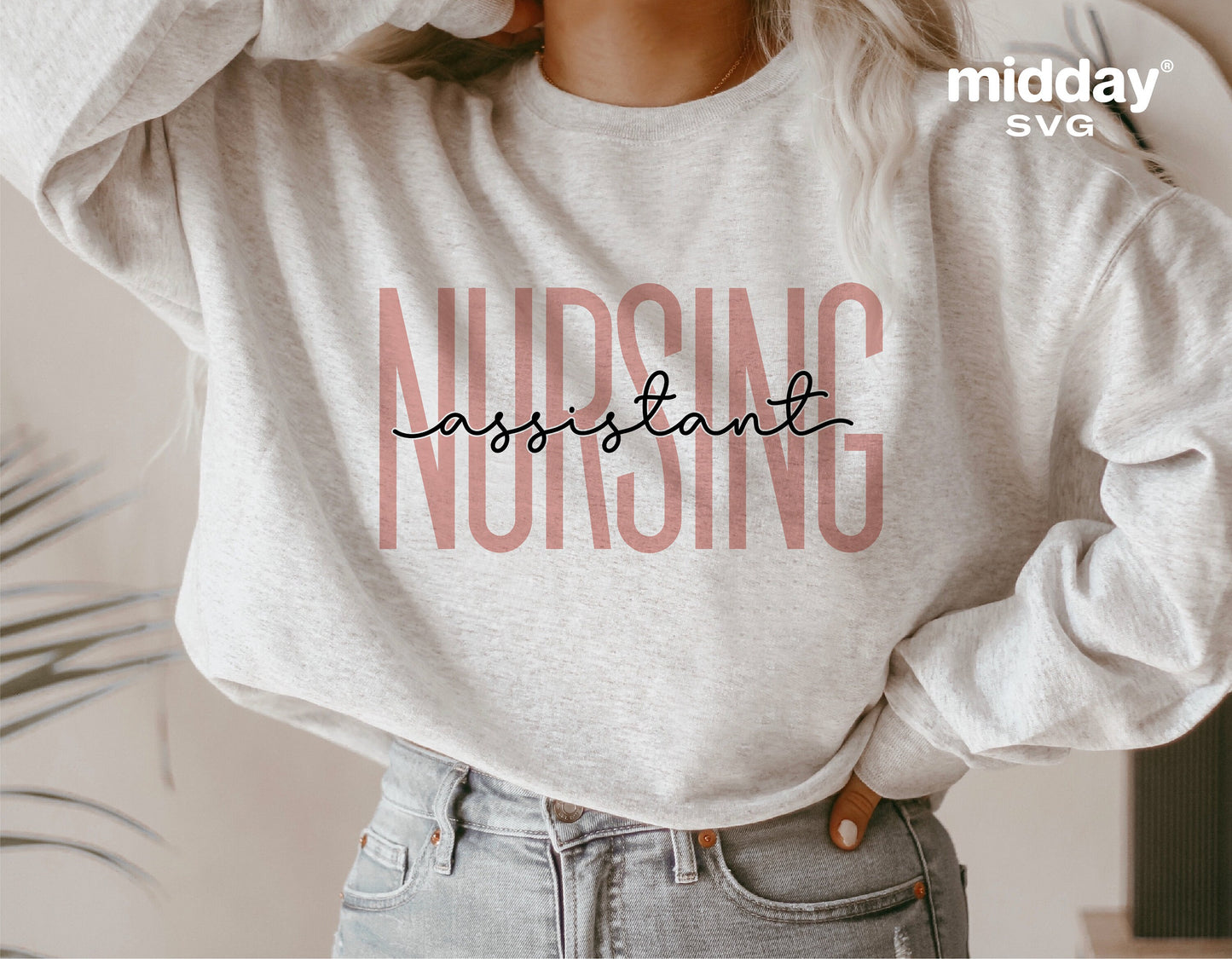 Woman wearing gray sweatshirt with 'Nursing Assistant' graphic, suitable for Cricut and Silhouette crafting, sublimation design.