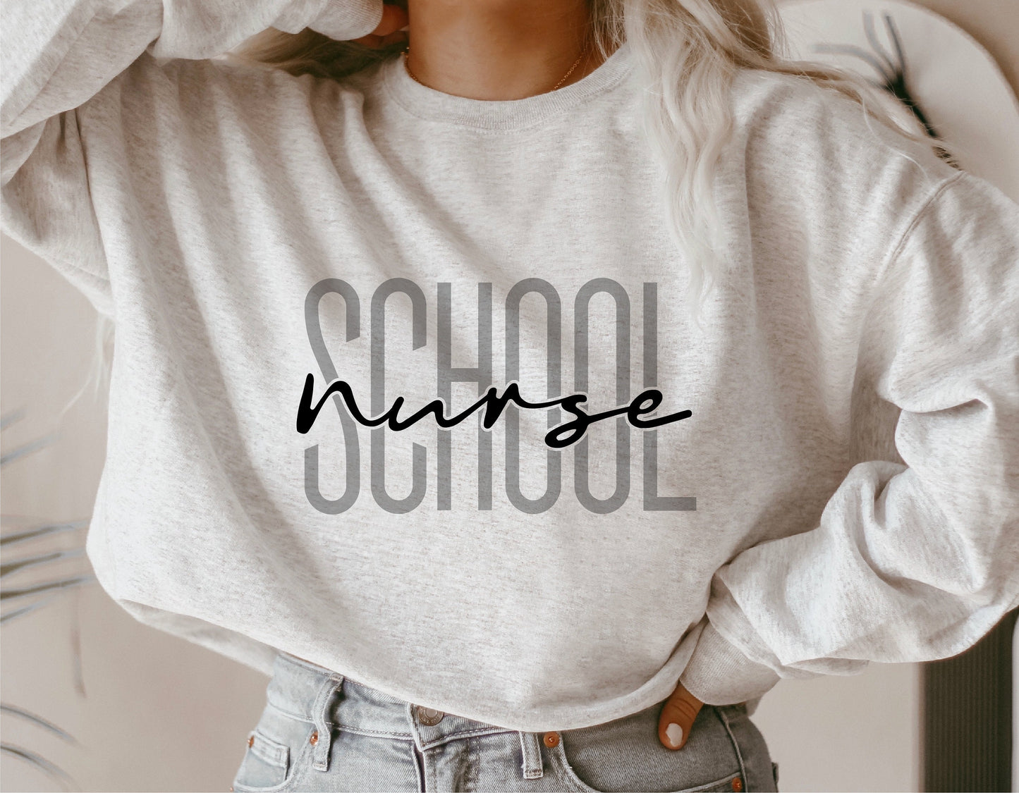 Cozy gray sweatshirt with 'School Nurse' text in bold and script fonts, perfect for school nurse apparel.