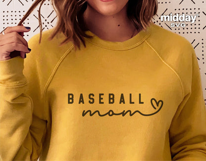 Woman wearing yellow sweatshirt with 'Baseball Mom' text graphic, suitable for Cricut and Silhouette designs.