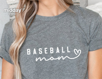 Woman wearing a gray t-shirt with 'Baseball Mom' written in white text, featuring a heart design. Perfect for sports enthusiasts.