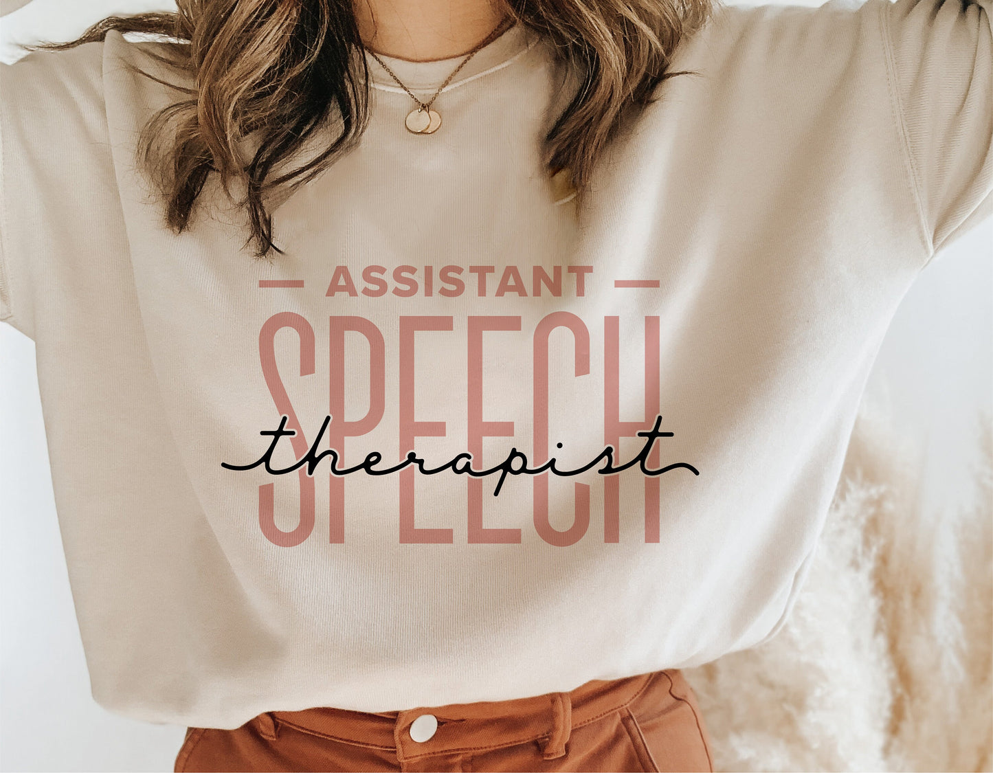 Woman wearing a beige t-shirt with 'Assistant Speech Therapist' design, ideal for speech therapy professionals, sublimation, and Cricut projects.