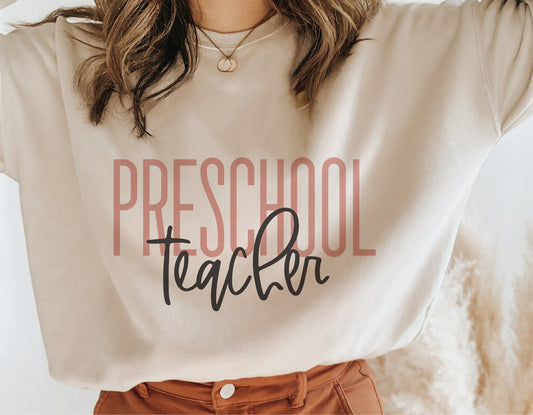 Woman wearing beige sweatshirt with 'Preschool Teacher' design, perfect for teacher gifts, Teacher Appreciation, and Cricut projects.