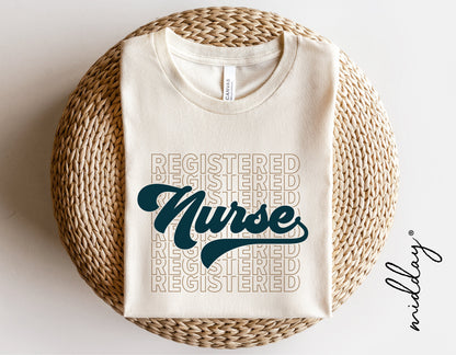 White t-shirt with 'Registered Nurse' design in teal and beige, folded on a woven surface, ideal gift for nurses.