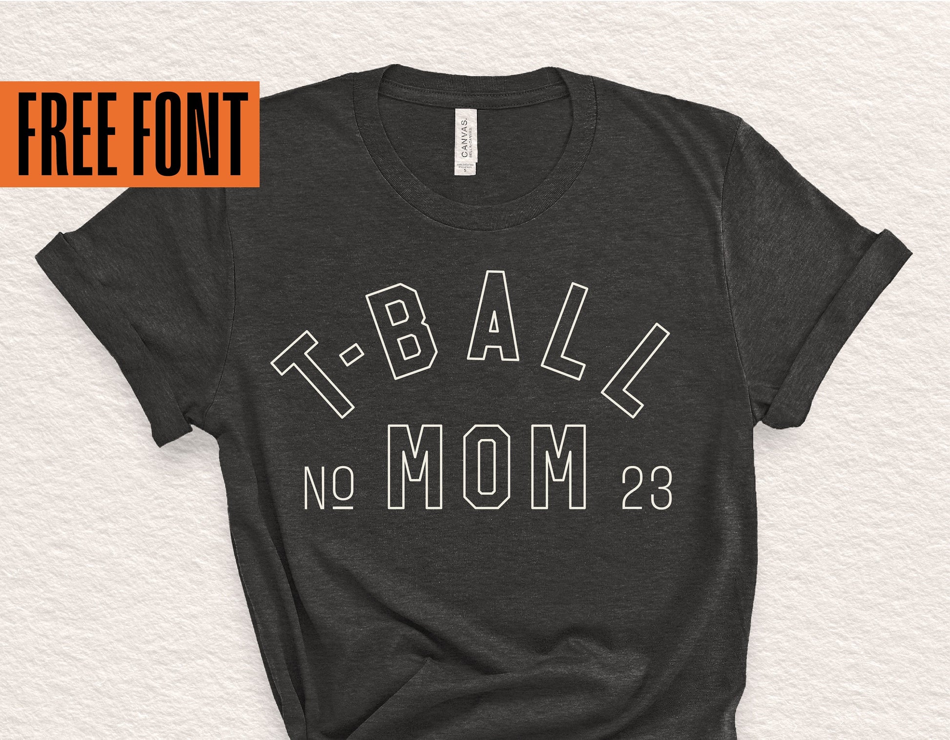 Black t-shirt with 'T-Ball Mom No. 23' design, highlighting free font text, perfect for Cricut and Silhouette crafts.