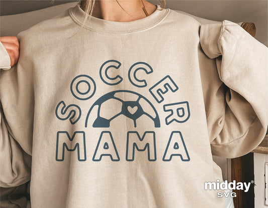Woman wearing beige "Soccer Mama" sweatshirt with heart soccer ball design, perfect for sports moms and Cricut projects.
