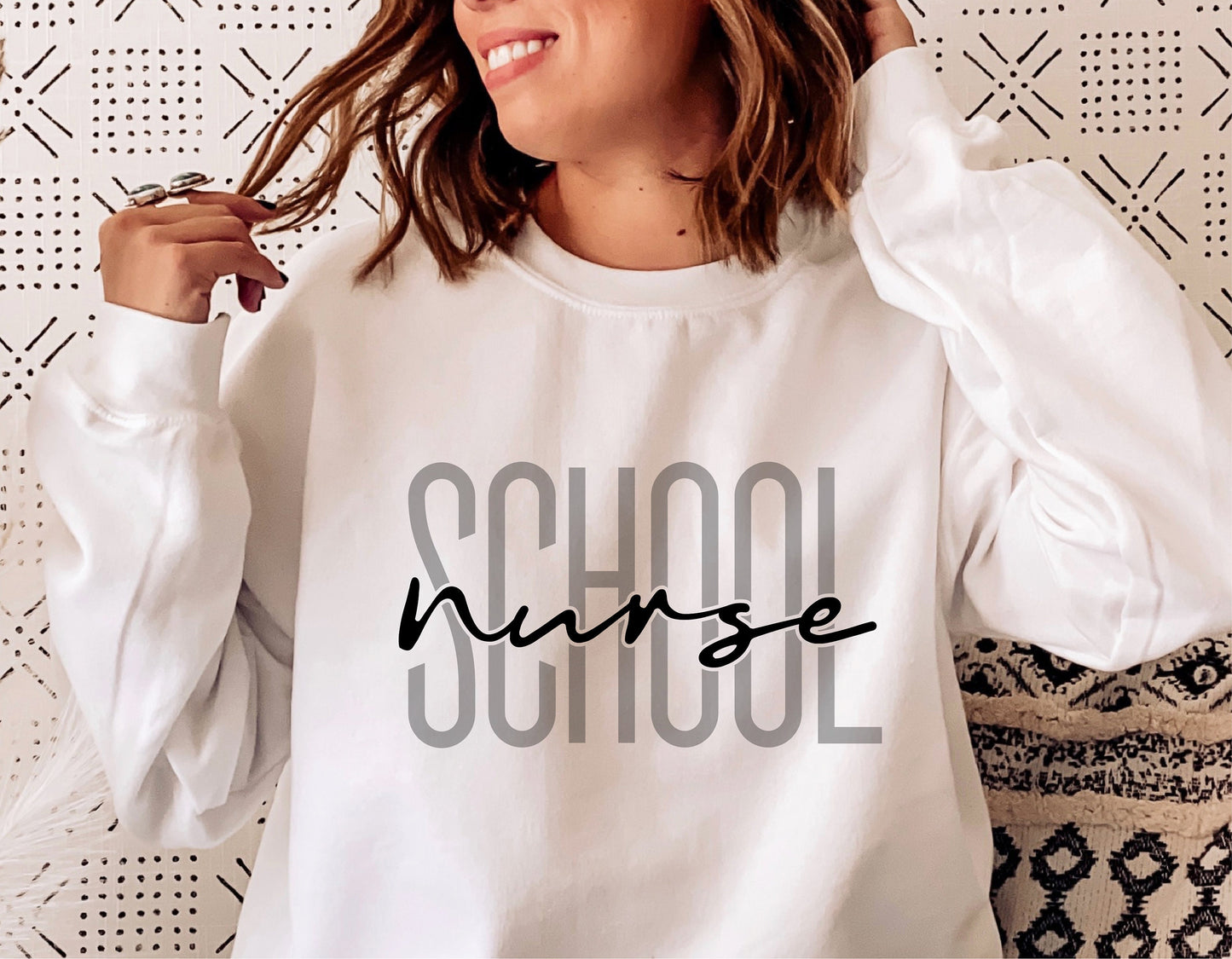 White sweatshirt with 'School Nurse' text design, casual clothing for nursing professionals.