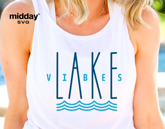 Woman wearing white tank top with blue 'Lake Vibes' design, perfect for lake vacation, camping, and summer outings.