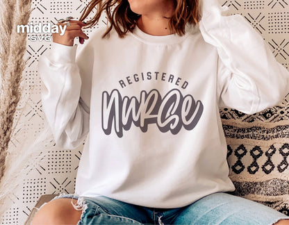 Woman wearing white sweatshirt with 'Registered Nurse' design, suitable for Cricut and Silhouette projects.
