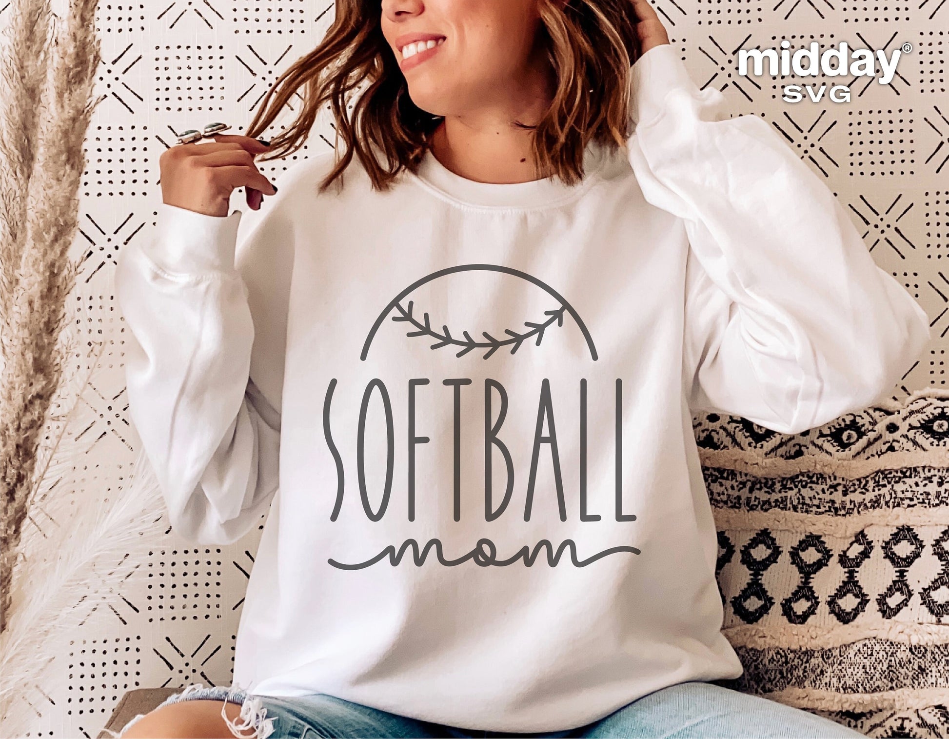 Woman wearing a white sweatshirt with Softball Mom design, perfect for Cricut and Silhouette projects, includes SVG, PNG, AI, EPS, and DXF files.