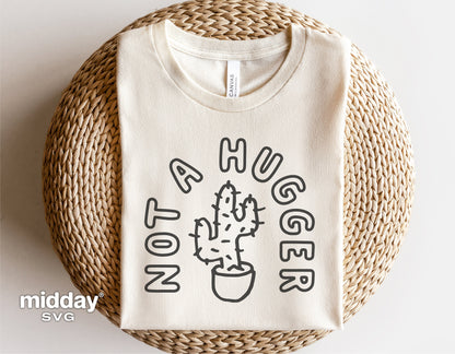 Funny "Not a Hugger" cactus design on a folded beige t-shirt, ideal for gardening enthusiasts, in SVG format for Cricut and Silhouette.