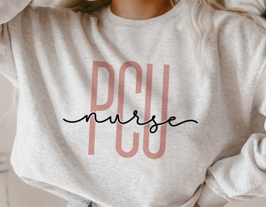 PCU nurse shirt showcasing a stylish nurse logo design in soft pink and black, ideal for progressive care unit nurse enthusiasts.