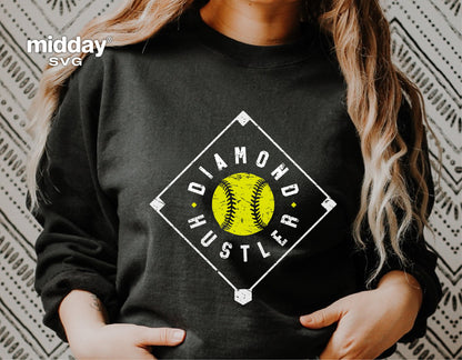Person wearing black sweatshirt with 'Diamond Hustler' softball design, ideal for Cricut SVG and sublimation projects.