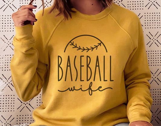 Woman wearing yellow sweatshirt with 'Baseball Wife' design, ideal for Cricut and Silhouette crafting. Perfect for shirts, tumblers, hoodies.