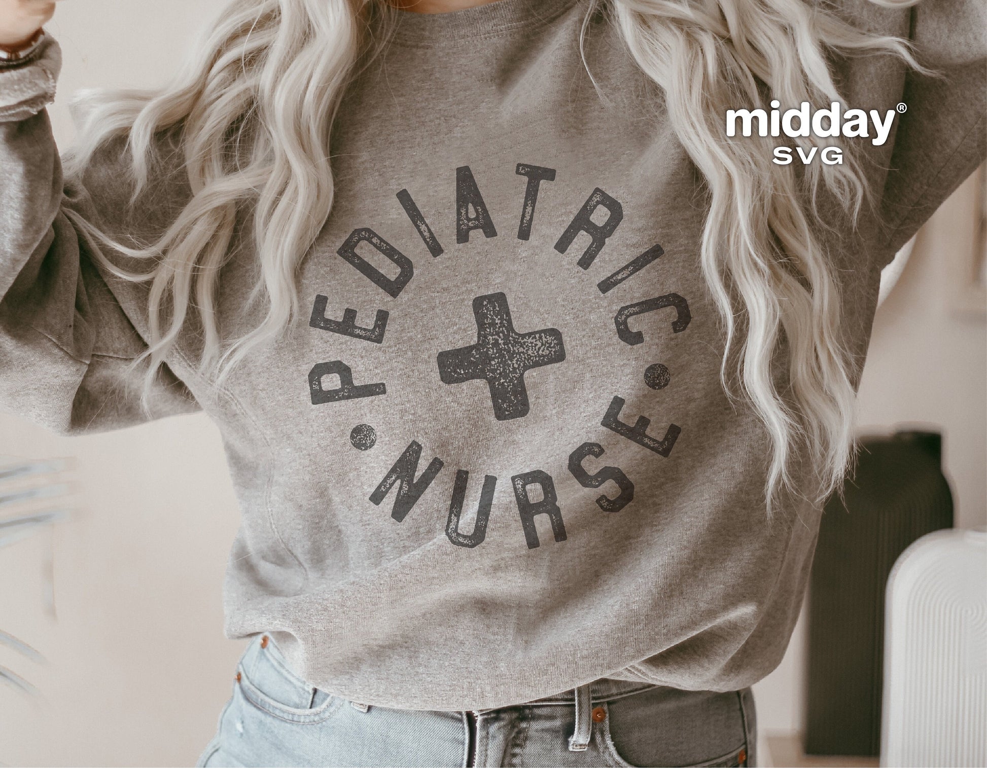 Gray sweatshirt with black 'Pediatric Nurse' design, worn by a model. Ideal for nurse badge reels, stickers, shirts, and Cricut projects.