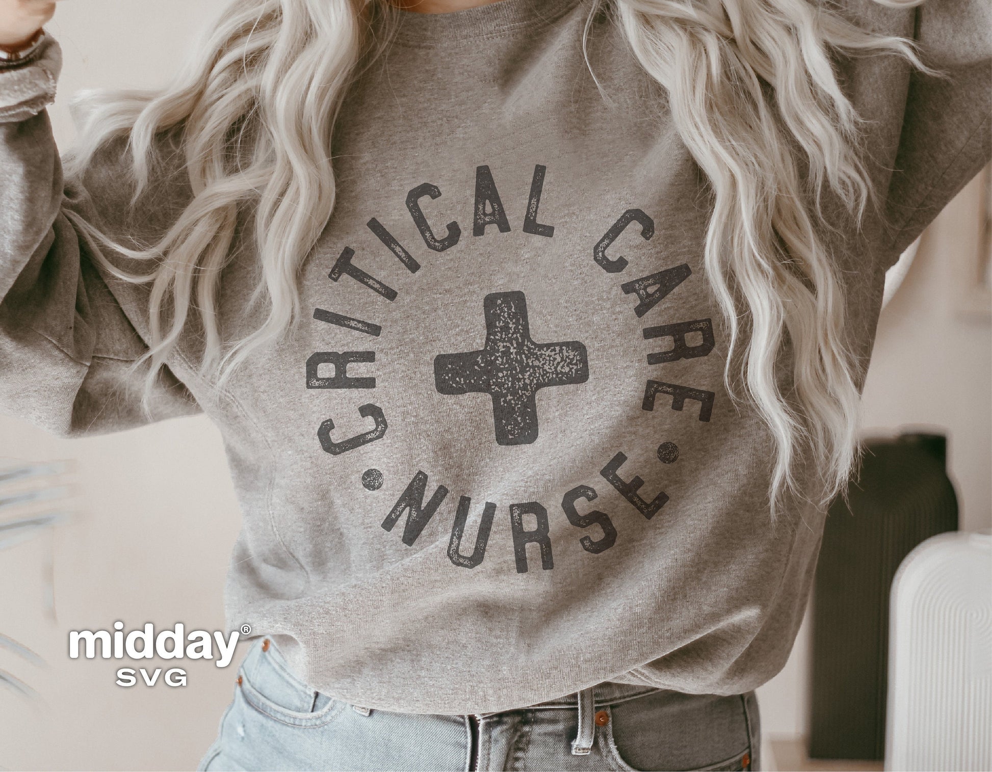 Grey sweatshirt featuring 'Critical Care Nurse' design in bold letters for healthcare professionals.