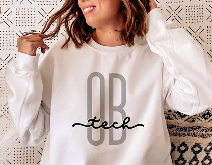 Woman wearing white sweatshirt with 'OB Tech' design for obstetrical technicians.