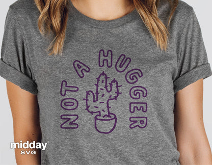 Gray shirt with 'Not a Hugger' text and cactus illustration, funny sarcastic design ideal for gardeners, compatible with Cricut and Silhouette.