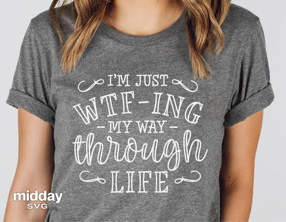 Woman wearing a gray t-shirt with 'I'm Just WTFing My Way Through Life' sarcastic quote, suitable for Cricut and Silhouette projects.