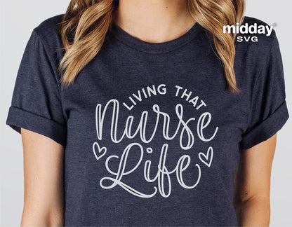 Woman wearing 'Living That Nurse Life' t-shirt in dark grey, showcasing nurse-themed design with heart accents.