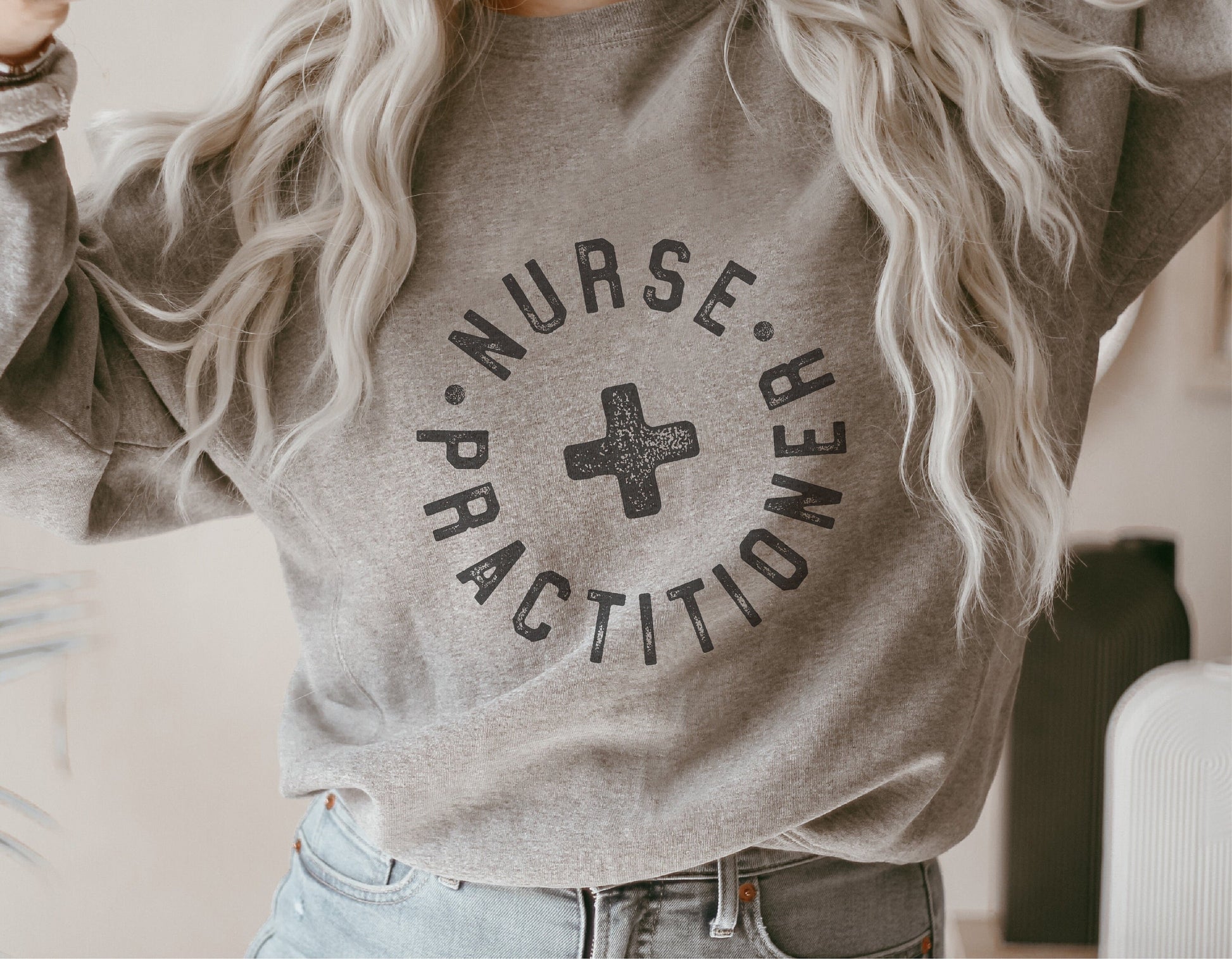 Gray sweatshirt featuring a Nurse Practitioner decal for mugs, shirts, and stickers, ideal for Cricut and Silhouette projects.