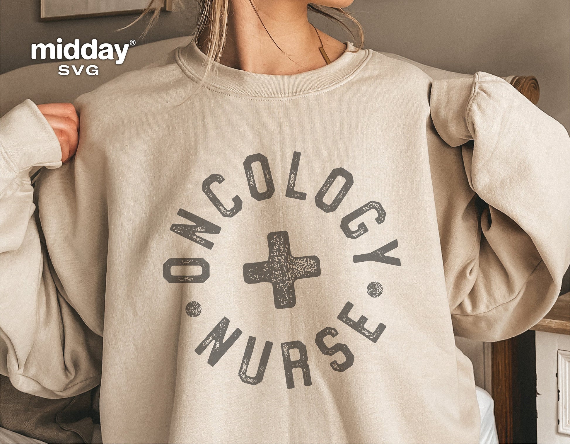 Person wearing a beige sweatshirt with 'Oncology Nurse' text and cross symbol, suitable for nurse-themed designs and apparel.