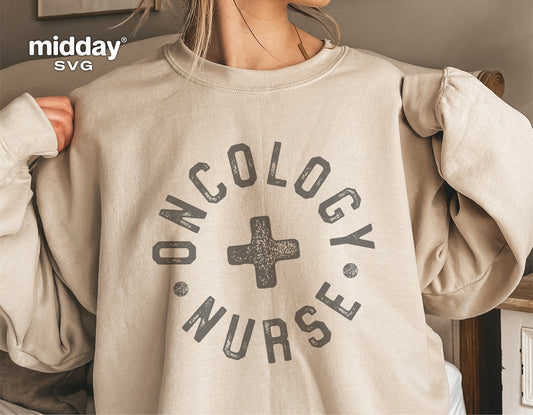 Person wearing a beige sweatshirt with 'Oncology Nurse' text and cross symbol, suitable for nurse-themed designs and apparel.
