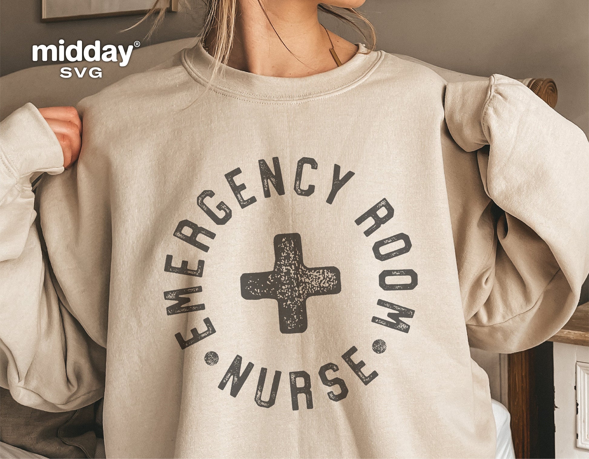Woman wearing beige sweatshirt with 'Emergency Room Nurse' design, ideal for ER nurse apparel, available in SVG format for Cricut and Silhouette.