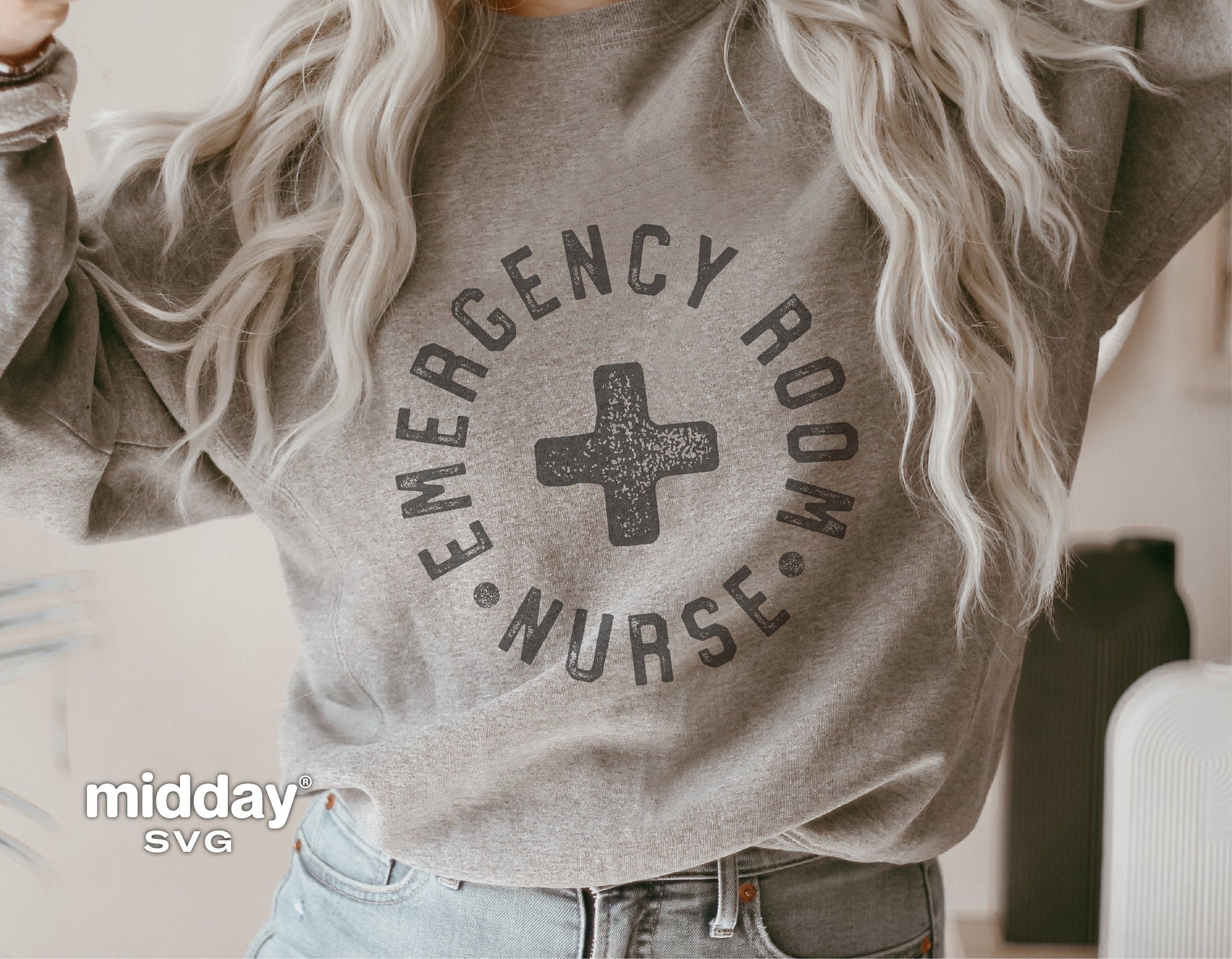 Woman wearing gray sweatshirt with 'Emergency Room Nurse' design featuring a medical cross, ideal for ER nurses and Cricut projects.