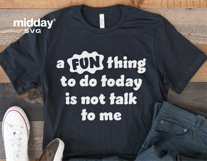 Black t-shirt with "A Fun Thing To Do Today is Not Talk To Me" text, casual fashion flat lay with sneakers and jeans.